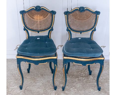 A pair of early 20th century French cained saloon chairs in Louis XV style, cained backs, serpentine cain seats all raised on