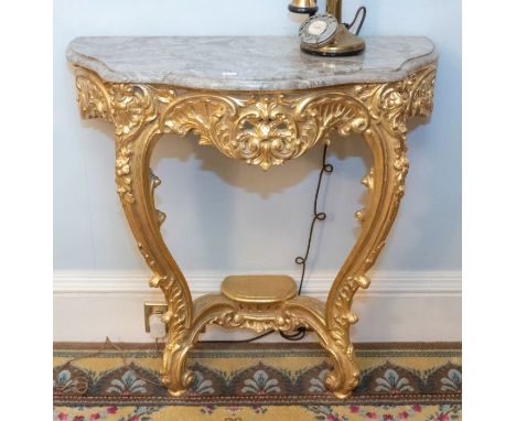 A pair of mid 20th century French marble topped and gilt wood wall mounted console tables, in Louis XVI style, moulded serpen