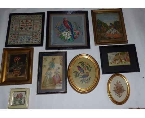 A group of 9 prints and needlework picturesto include a printed parrot , oil painting of a pot plant , a sampler and some nee