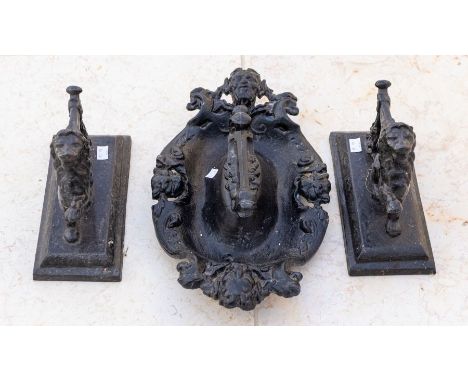 A cast metal painted foot scrapper, together with two cast metal door stopsPlease note this item is at an offsite location, b