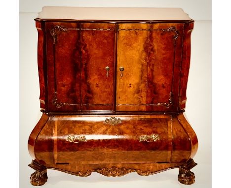 A 20th century walnut television cabinet, in the manner of a Dutch bombe Commode, serpentine shape moulded edge top, over two