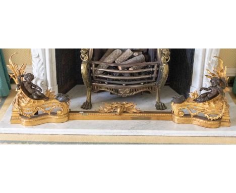A gilt metal fire surround , featuring two recoiled ebonised cherub figures, 153cm in lengthPlease note this item is at an of