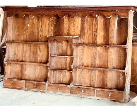 A George III oak dresser top, moulded cornice over a long shelf, above a serpentine interior shelves flanked by moulded plate