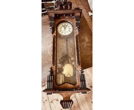 A 19th century walnut and ebonised Vienna wall clock, in a manner of Gustov Becker, carved finials on masked centre pediment.