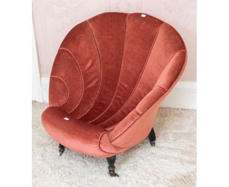 A late Victorian scalloped back nursing chair, raised on ebonsied turned front legs, terminating in castors 68cm H x 77cm W x