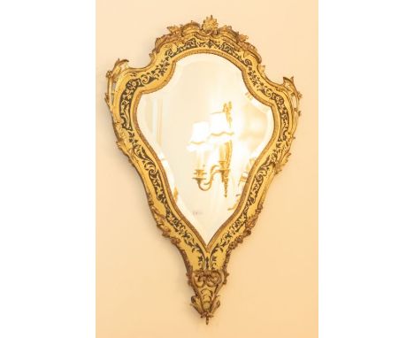 An early 20th century gilt and brass cartouche shaped mirror 87cm x 60cm Please note this item is at an offsite location, buy