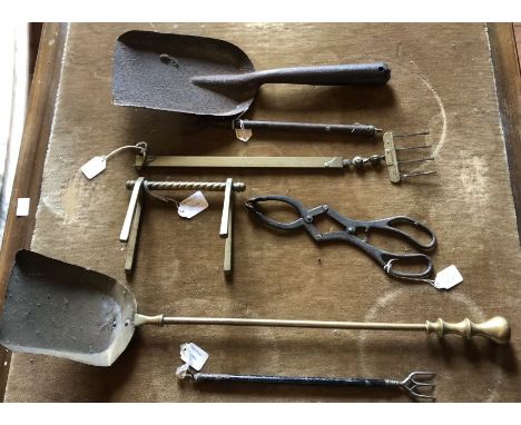 A selection of fire tools, comprising:- three toasting forks of differing sizes; a fork rest; a pair of ash nips; and two coa