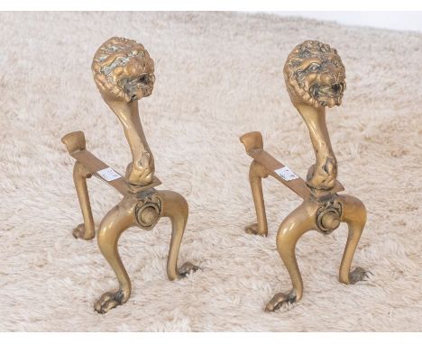 A pair of early 20th century cast brass fire dogs Please note this item is at an offsite location, buyers will be notified of