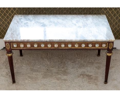 An early 20th century mahogany, brass and porcelain mounted coffee table in Louis XVI style, rectangular marble top, the frie