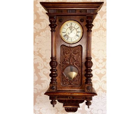 A 19th century mahogany Vienna wall clock by Gustav Becker, moulded cornice over a fluted and foliage carving, above an 8.5in