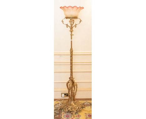 An early 20th century rococo style giltmetal floor light, with curved colour glass shade, 168cm HPlease note this item is at 