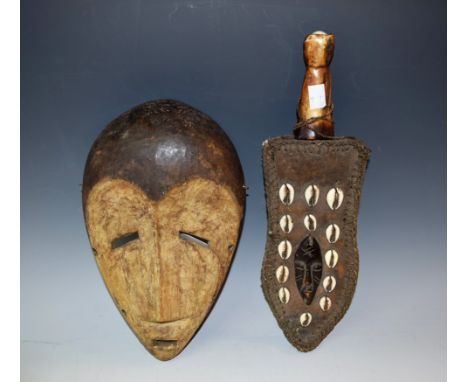 Tribal Art - a Dan mask, domed forehead, central ridge , sloping eyes, 28.5cm long, Ivory Coast; an African dagger, 22.5cm sh