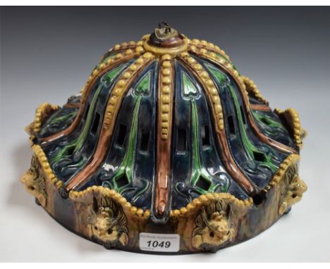 A Majolica ceiling light with lion mask rim