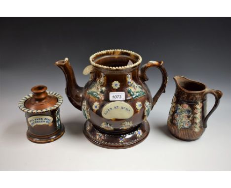 A Victorian Measham Bargeware teapot on stand, cover lacking, Love at Home, 23cm; a similar tobacco jar, replacement treen co