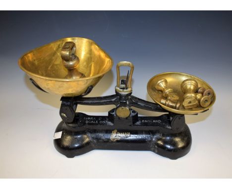 A set of cast iron scales, with brass pans, Libra Scale Co.; a set of nine brass weights