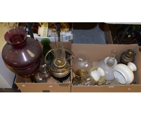 A mid 20th century Duplex oil lamp, ruby glass reservoir and shade supported on brass column; other oil lamps, shades, etc, q