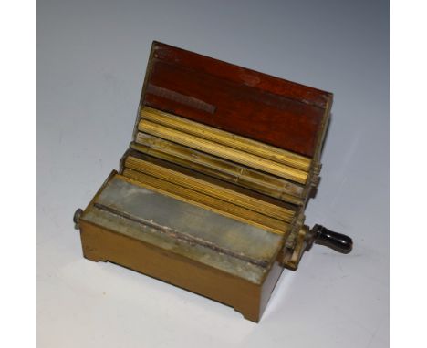 An early 20th century Evans & Co patent mahogany and brass cigarette making machine, hinged cover, cranking handle to side, b