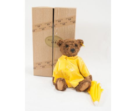 Steiff Mayfair teddy bear, dressed in yellow Mac with umbrella, boxed. 