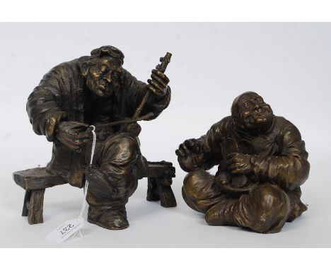 A pair of heavy cast vagabond bronze figurines, one of a musician and one of a shoesmith. H19cm 