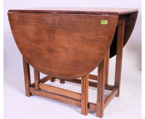 A good Ercol beech and elm drop leaf dining table raised on squared legs united by low stretchers. Measures: 73 x 90 x 49.