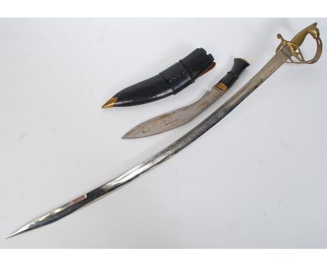 A 20th century vintage Indian hanging decorative sword, with decorated brass handle in the shape of a lion, with original she
