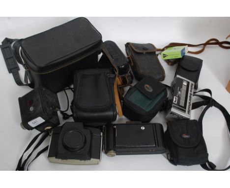 A collection of cased vintage cameras to include Kodak and many more examples