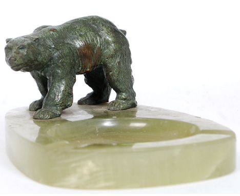 A 1920's Art Deco hardstone - agate ashtray having recess flanked by bronze model of a polar bear