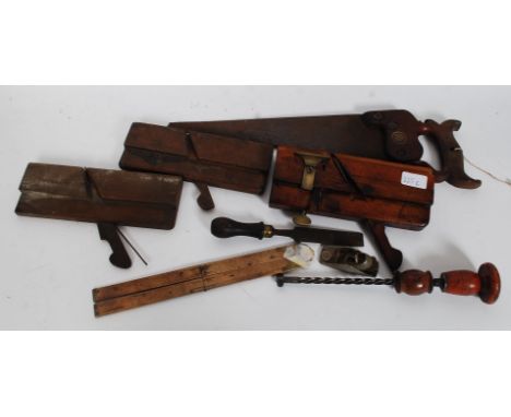 A collection of vintage woodworking tools to include an Holbrook plane along with other planes and measures etc