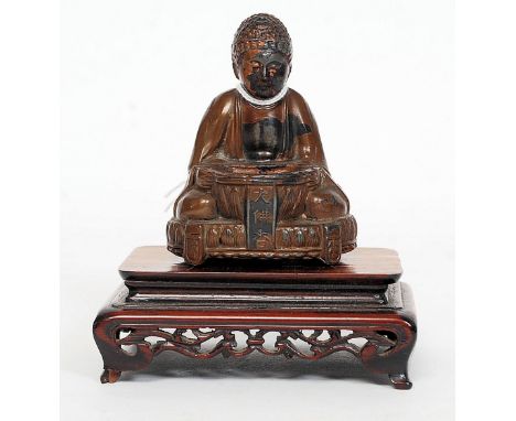 A 19th / 20th century hollow case bronze Chinese figurine of Buddha - deity in a seated position with vessel in hands and sat