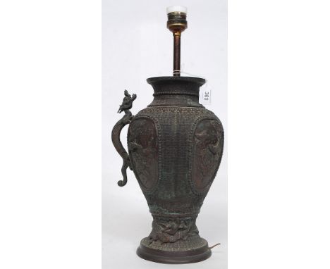 A 19th century Chinese - Japanese bronze vase of large form. Embellished with dragon to centre, geometric carved ground with 