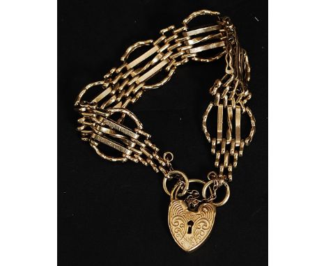 A 9ct gold 6 bar circular gate-link bracelet hallmarked for London with saftey chain. The lock bearing stylised swirls. Weigh