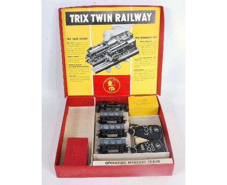 A Trix Twin Railway red box containing parts for an operating mineral train, 3 hopper wagons, goods brake with lights,freelan