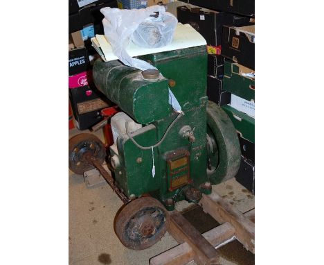 A RA Lister &amp; Co. model No. 26DH petrol  engine, raised on wooden display base with a box of additional fixtures, fitting
