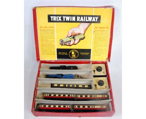 A Trix Twin Railway red set box containing 2x freelance 0-4-0 engines and tender, one in lined light blue BR emblem, the othe