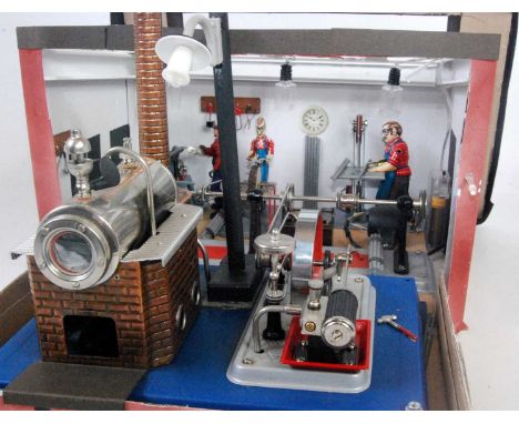 A Willesco D10/D105 steam plant comprising of a tin housed horizontal boiler with brickwork effect chimney, powering a single