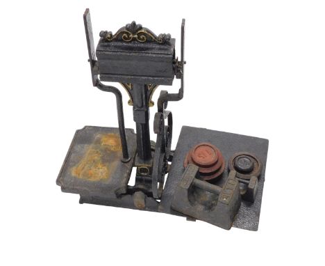 A set of Victorian cast iron scales, with various associated weights, 35cm wide.