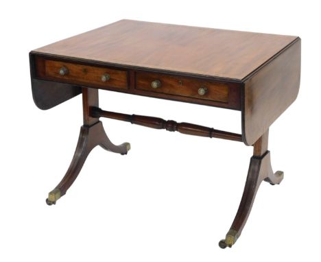 A Regency mahogany and rosewood cross banded sofa table, the rectangular top with rounded corners, above two frieze drawers o