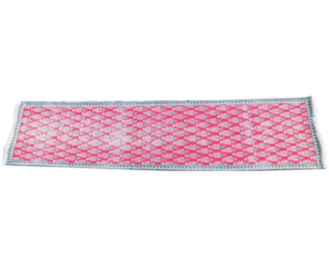 A Persian red ground runner, decorated with multiple medallion within one wide and two narrow borders, 286cm x 68cm.