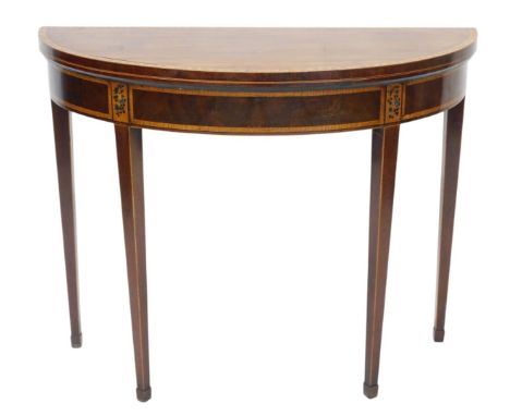A George III mahogany and satinwood cross banded demi lune card table, the cross banded border painted with berries and leave