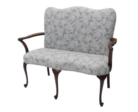 A mahogany sofa, in George III style, with a shaped back and seat upholstered in grey floral fabric, shepherd's crook shaped 