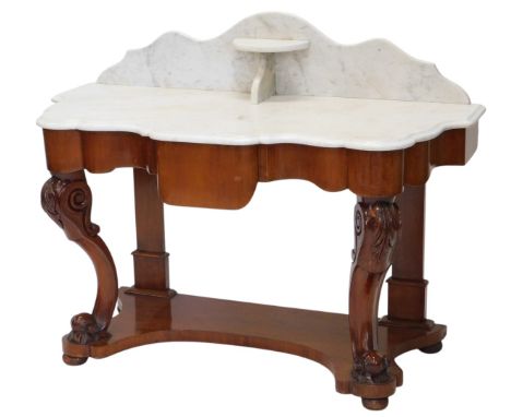A Victorian mahogany washstand, the white marble top with a raised back and shelf above a shaped frieze with central drawer, 