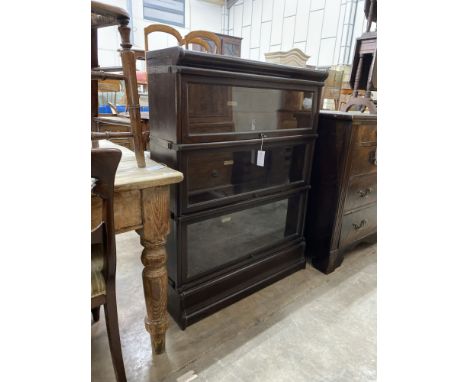 A Globe Wernicke three section glazed oak bookcase, length 86cm, depth 27cm, height 115cm