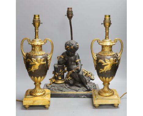 A pair of ornate guilt vase style lamps on marbled base, together with a seated cherub table lamp, 45cm tall, (3)