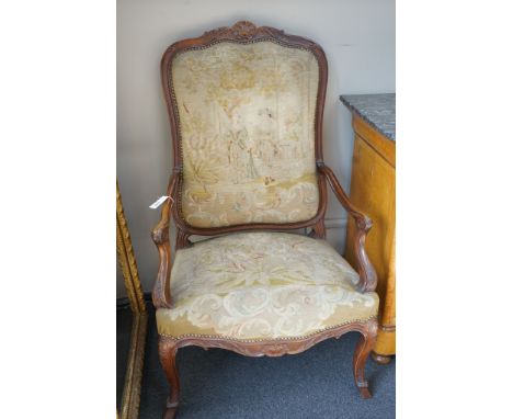 A pair of French carved walnut fauteuils with tapestry upholstery, width 75cm, depth 62cm, height 120cm