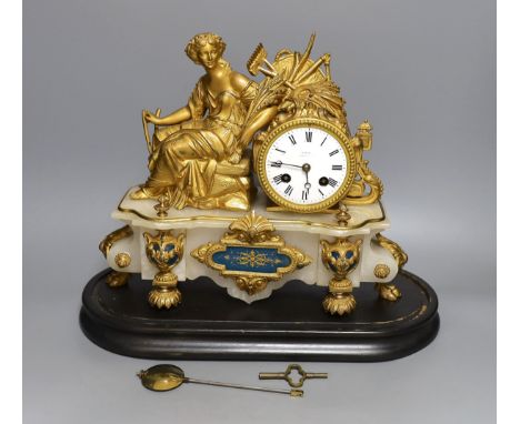 A 19th century French gilt metal and alabaster figural mantle clock with key and pendulum