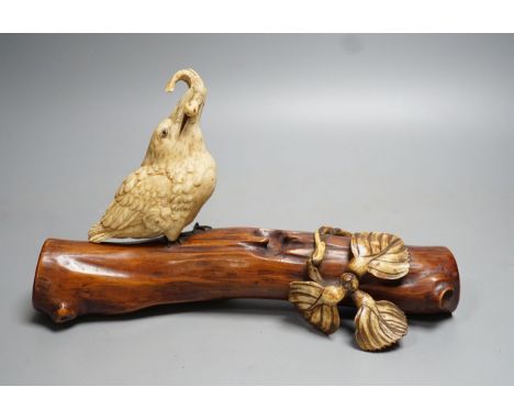 A 19th century Japanese ivory okimono of a kingfisher and log, mother of pearl inset eyes, signed to underside (a.f) 25cm lon