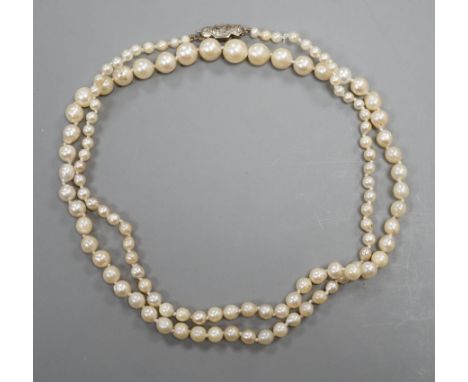 A single strand graduated cultured pearl necklace, with diamond chip set white metal clasp, 54cm, gross weight 13 grams.