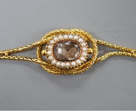 A late Victorian 15ct, seed pearl and plaited hair set twin strand mourning bracelet, approx. 15.5cm, gross weight 7.6 grams 