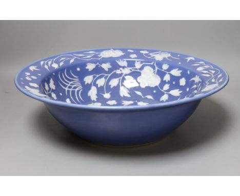 A Chinese export slip decorated blue ground basin, c 1830 - 40cm diameter