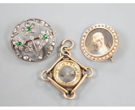 An American 10k yellow metal compass pendant, 29mm, gross 7.1 grams, a 585 and split pearl set circular portrait brooch, gros